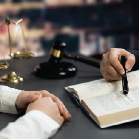 Lawyer pointing to a book and explaining something to another person