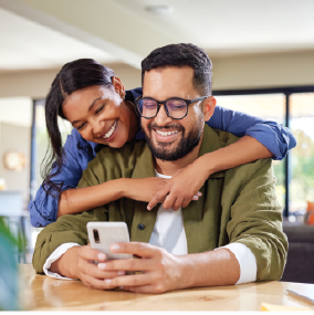 Young ethnic couple embracing at coffee table